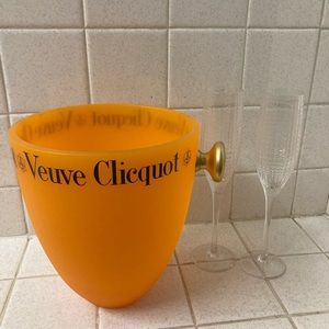 Veuve Cliquot orange ice bucket with 2 champagne flutes.